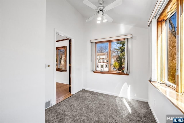 unfurnished room with ceiling fan, vaulted ceiling, and carpet