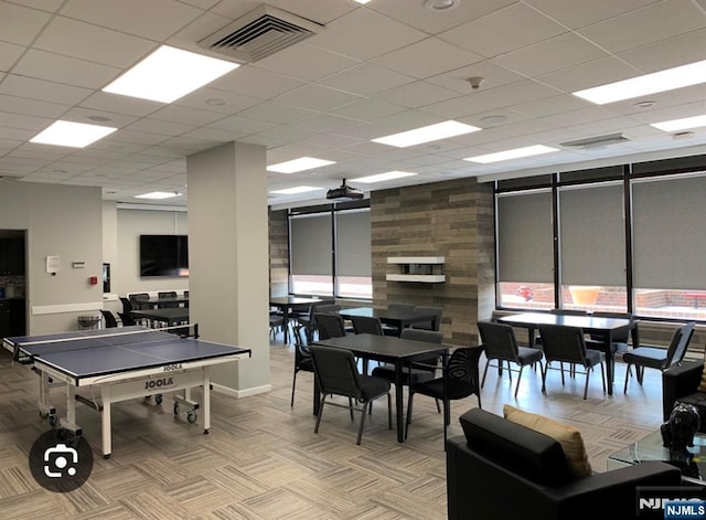 recreation room featuring light carpet