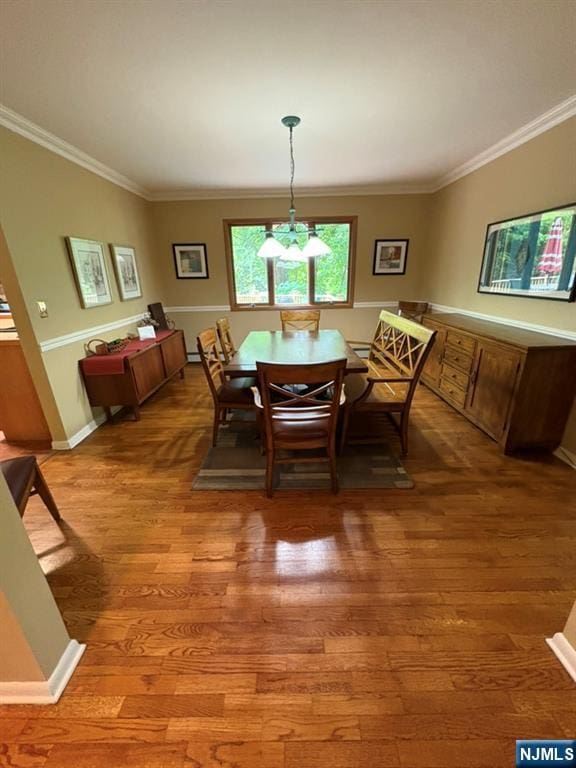 103 Northwood Ave, Demarest, NJ 07627 - dining room with light wood-style floors, ornamental molding, a chandelier, and baseboards