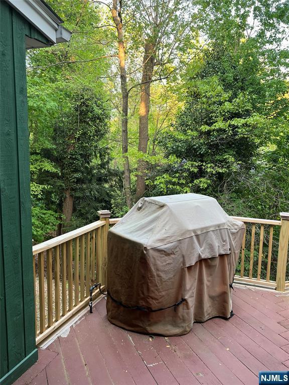 wooden terrace featuring a grill