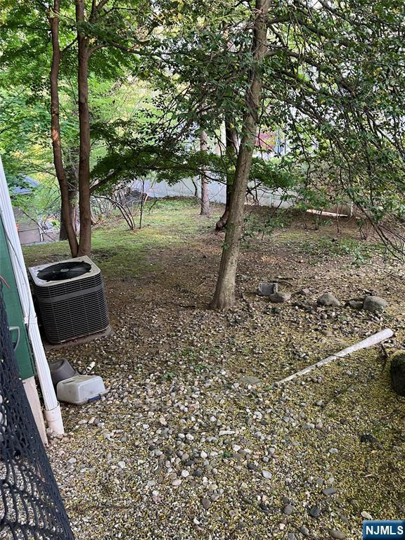 view of yard featuring central air condition unit
