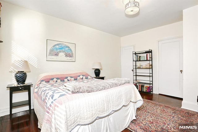 bedroom featuring dark wood-type flooring