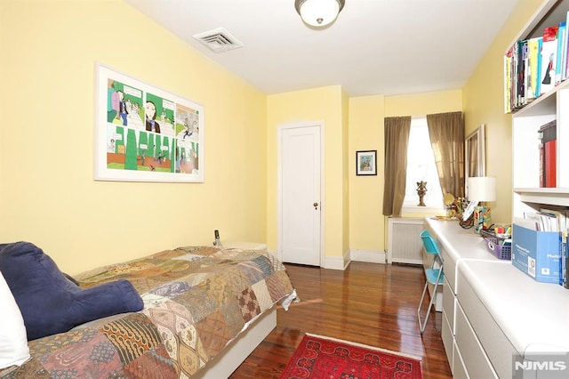 bedroom featuring dark hardwood / wood-style floors and radiator heating unit