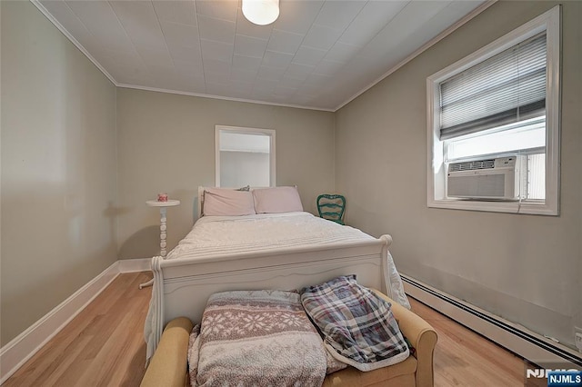 bedroom with ornamental molding, a baseboard heating unit, cooling unit, and light hardwood / wood-style flooring