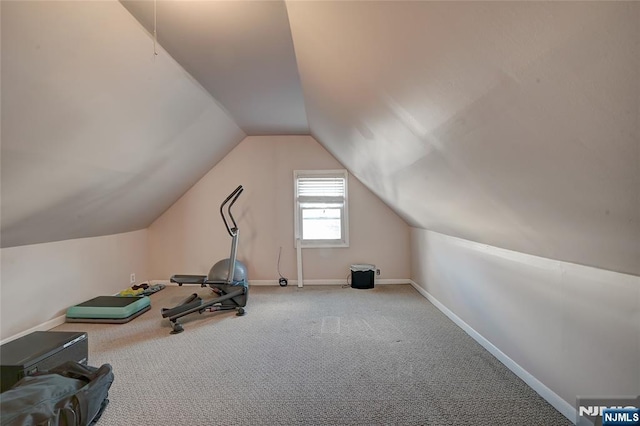 exercise area featuring lofted ceiling and carpet