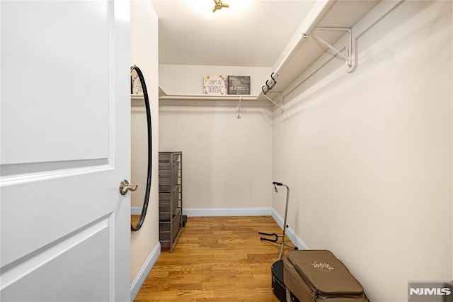 walk in closet featuring light hardwood / wood-style flooring