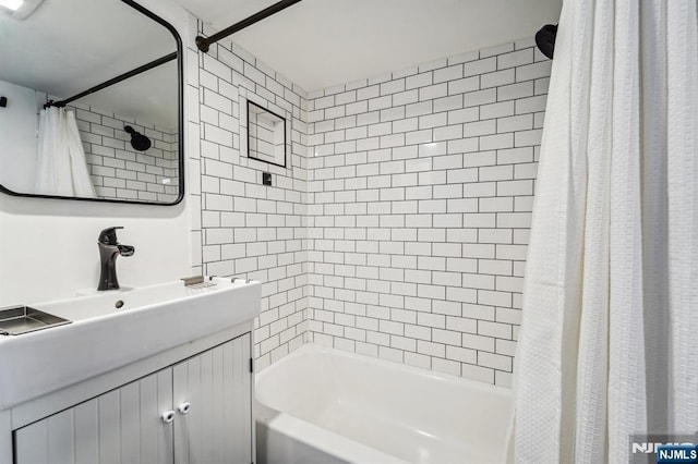 bathroom featuring vanity and shower / bath combination with curtain