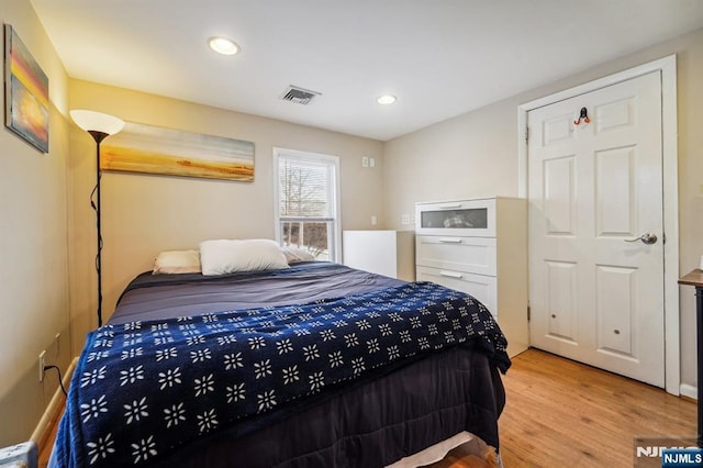 bedroom with hardwood / wood-style flooring