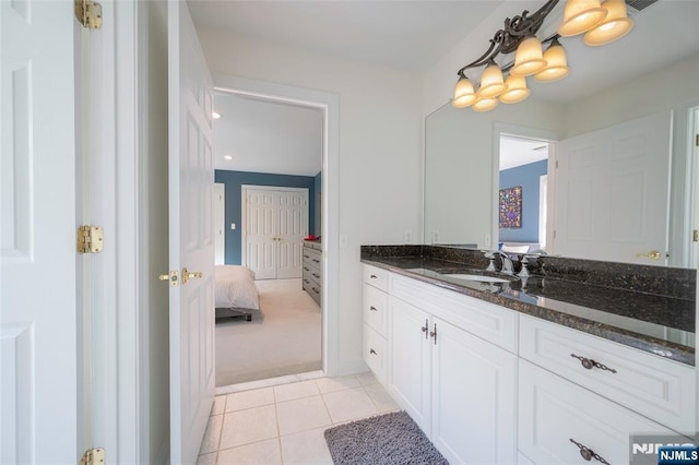 ensuite bathroom featuring tile patterned flooring, vanity, and ensuite bathroom