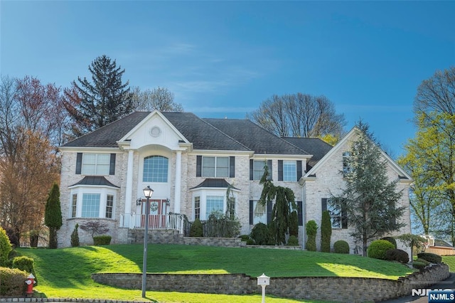 neoclassical / greek revival house with a front lawn