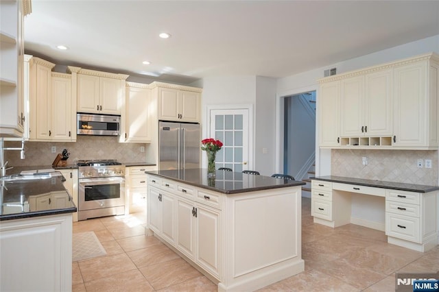 kitchen featuring premium appliances, a kitchen island, a sink, visible vents, and open shelves