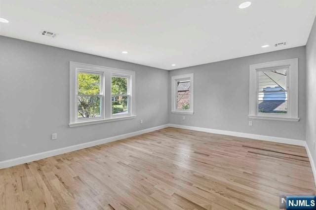 spare room with light hardwood / wood-style flooring