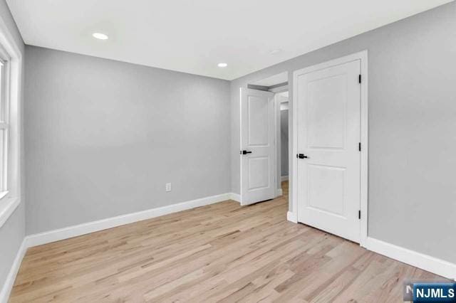 empty room with light hardwood / wood-style flooring