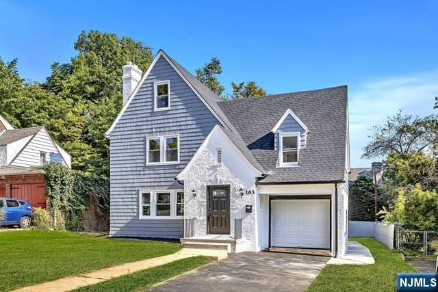 view of front of house featuring a garage and a front lawn