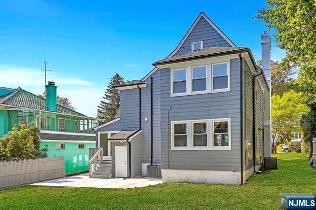 back of house with a patio, a yard, and cooling unit