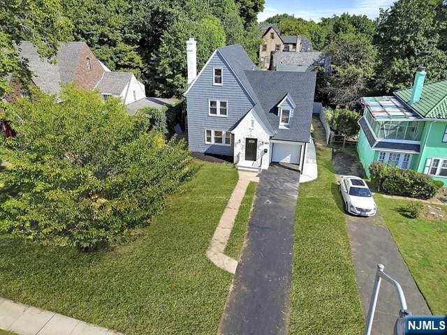 view of front of property with a garage and a front lawn