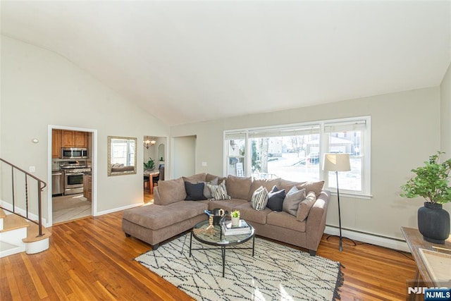 living room featuring a baseboard radiator, vaulted ceiling, hardwood / wood-style floors, and an inviting chandelier