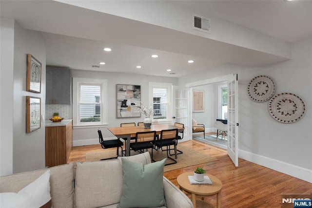 dining area featuring light wood-type flooring and french doors