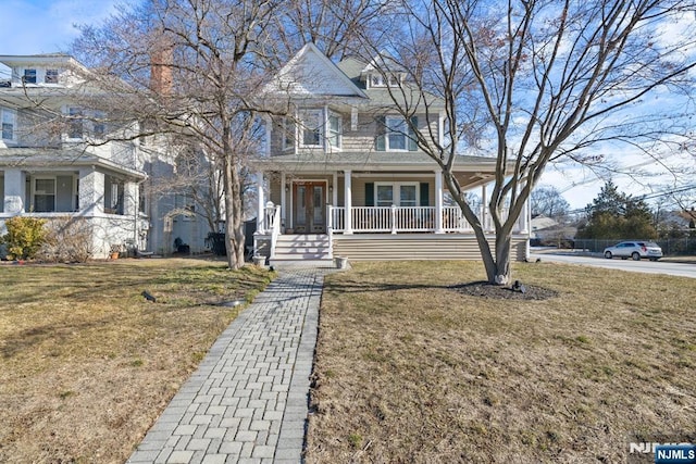 view of front of home with a porch and a front yard