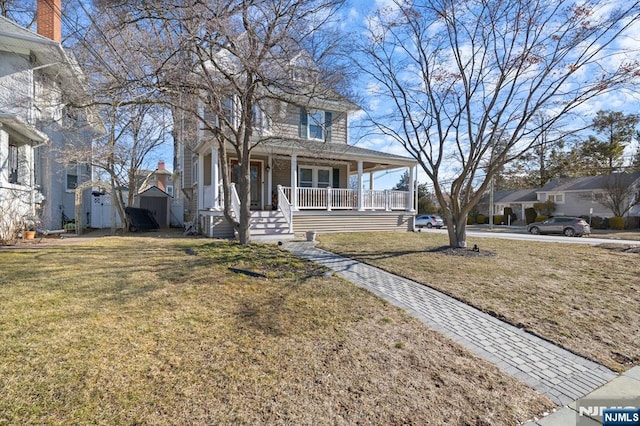 view of front facade with a residential view, a front lawn, and a porch