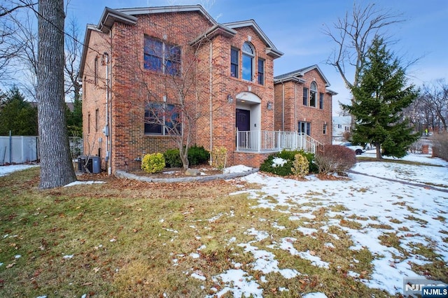 view of property featuring cooling unit and a yard