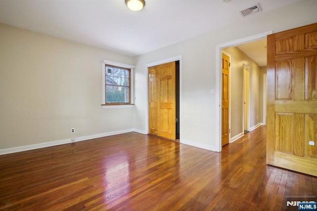 empty room with dark hardwood / wood-style floors