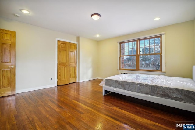 unfurnished bedroom featuring dark hardwood / wood-style floors