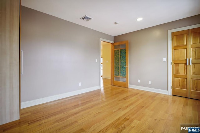 spare room with light wood-type flooring