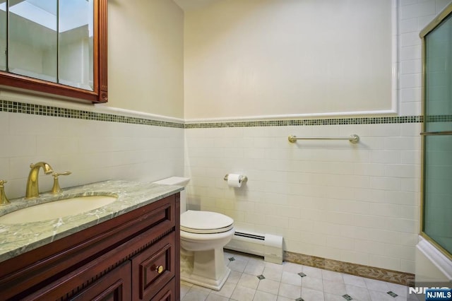 bathroom with baseboard heating, tile patterned flooring, vanity, toilet, and walk in shower