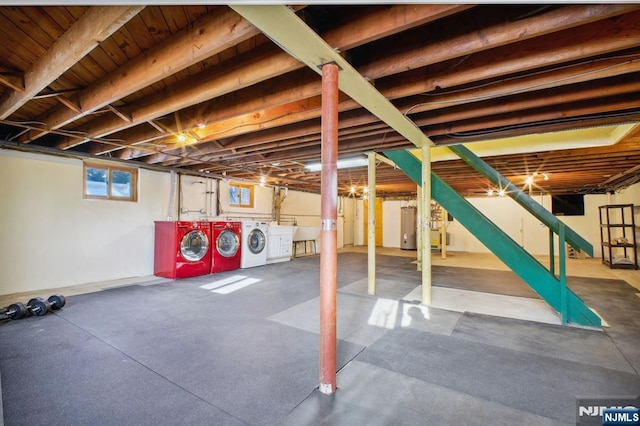 basement featuring washer and clothes dryer and water heater