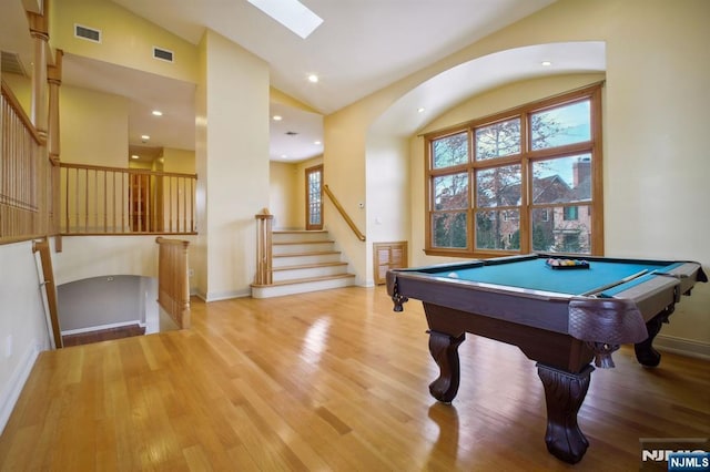 playroom with billiards, lofted ceiling with skylight, and light wood-type flooring