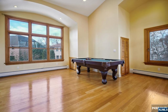 recreation room featuring a baseboard heating unit, pool table, vaulted ceiling, and light wood-type flooring