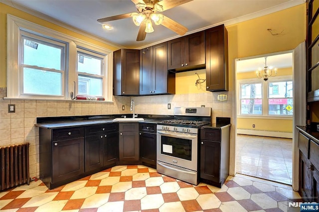 kitchen featuring radiator heating unit, plenty of natural light, sink, and stainless steel range with gas stovetop