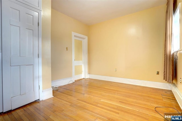 unfurnished room with light hardwood / wood-style floors