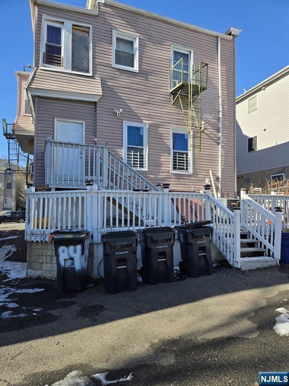 back of property featuring a deck