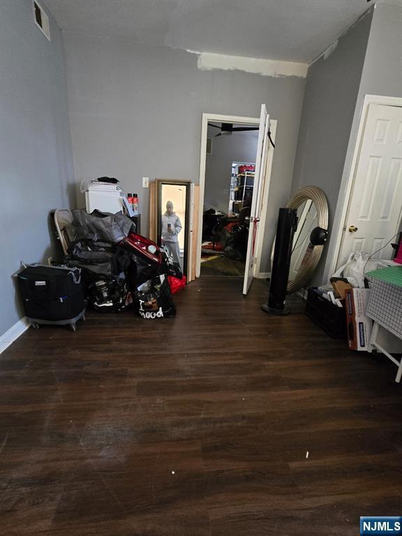 bedroom with dark hardwood / wood-style floors