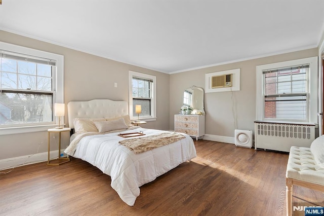 bedroom featuring crown molding, radiator heating unit, wood-type flooring, and an AC wall unit