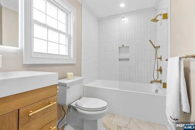 full bathroom featuring tiled shower / bath, vanity, and toilet