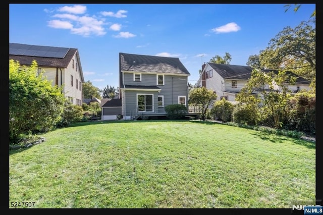 back of house with a lawn