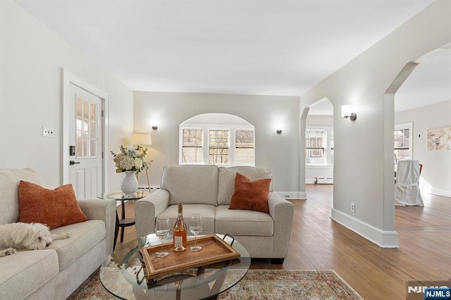 living room featuring hardwood / wood-style flooring and baseboard heating