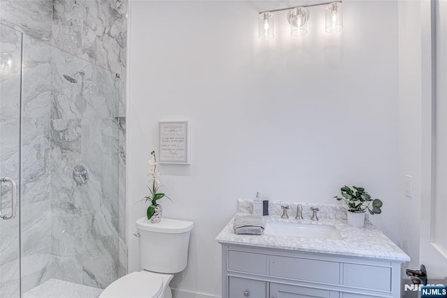 bathroom with walk in shower, vanity, and toilet