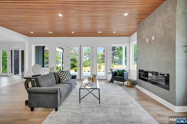 sunroom with wood ceiling and a fireplace