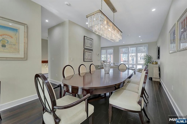 dining area featuring a notable chandelier and dark hardwood / wood-style floors