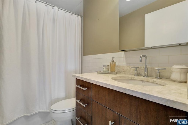 bathroom with vanity, toilet, and a shower with shower curtain