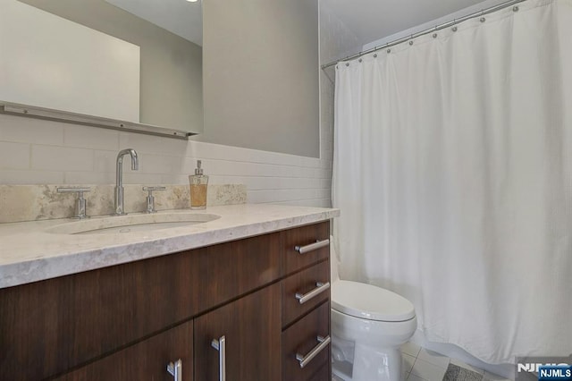 bathroom with tile patterned floors, vanity, and toilet