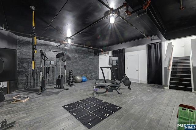 exercise room with hardwood / wood-style floors