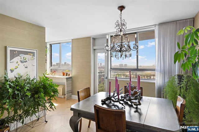 dining space featuring a notable chandelier and light parquet floors