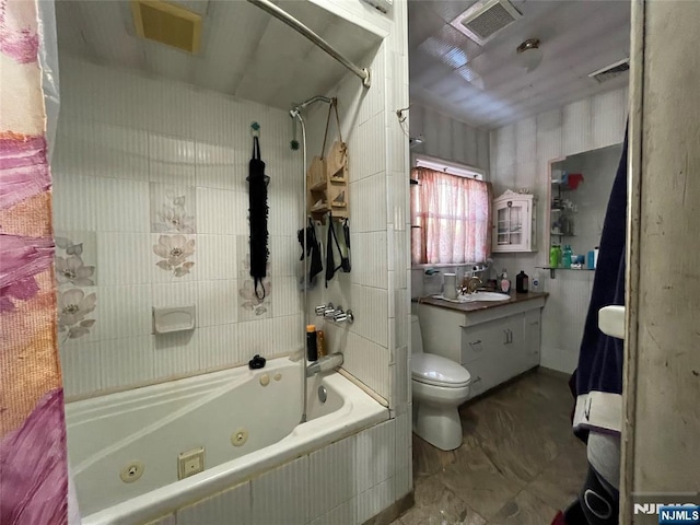 full bathroom with tiled shower / bath combo, vanity, and toilet