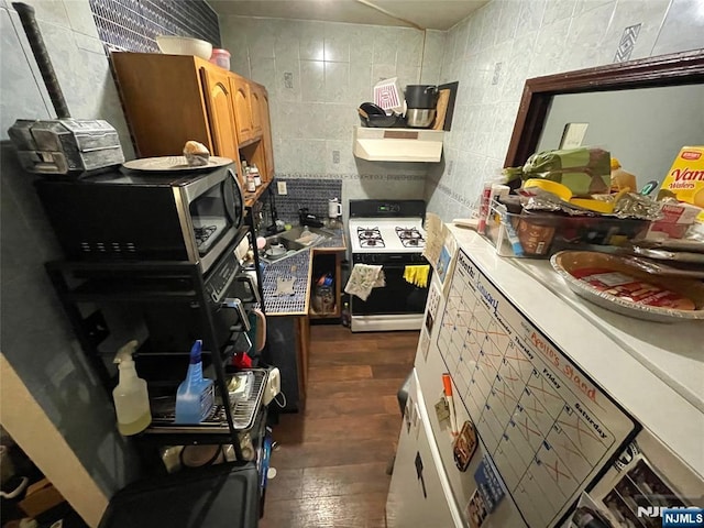 kitchen with dark hardwood / wood-style floors, tile walls, decorative backsplash, and gas range gas stove