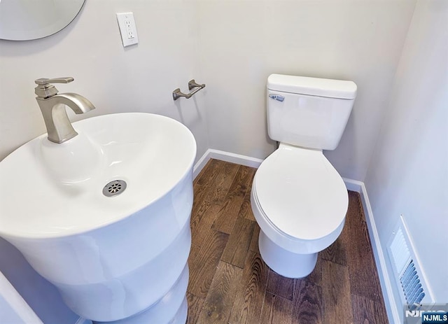 bathroom featuring sink, wood-type flooring, and toilet